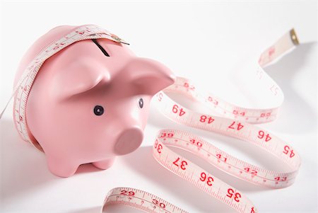 simsearch:640-01355019,k - Close-up of a piggy bank wrapped with a tape measure Stock Photo - Premium Royalty-Free, Code: 625-01249616