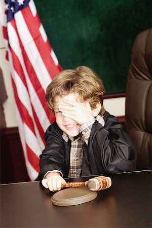Boy imitating a judge Stock Photo - Premium Royalty-Free, Code: 625-01249620