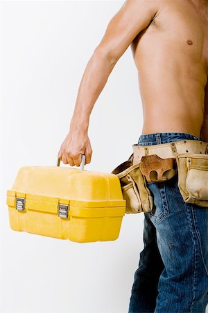 Mid section view of a man holding a toolbox Foto de stock - Sin royalties Premium, Código: 625-01249795