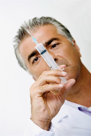 doctor syringe close up - Close-up of a male doctor holding a syringe Stock Photo - Premium Royalty-Free, Code: 625-01249814