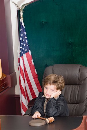 Boy imitating a judge Stock Photo - Premium Royalty-Free, Code: 625-01249812