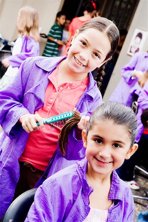simsearch:625-01752943,k - Portrait of a girl combing her sister's hair in a salon Stock Photo - Premium Royalty-Free, Code: 625-01250002