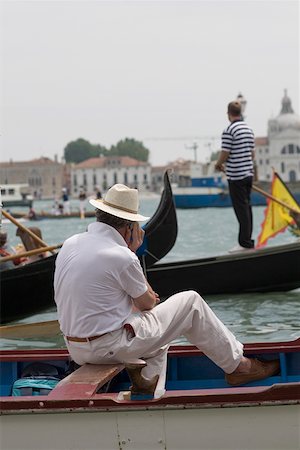 simsearch:625-01750740,k - Rear view of a man sitting in a gondola, and using a mobile phone Venice, Veneto, Italy Stock Photo - Premium Royalty-Free, Code: 625-01250016