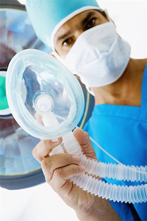 simsearch:625-01252179,k - Portrait of a male surgeon holding an oxygen mask Stock Photo - Premium Royalty-Free, Code: 625-01250099