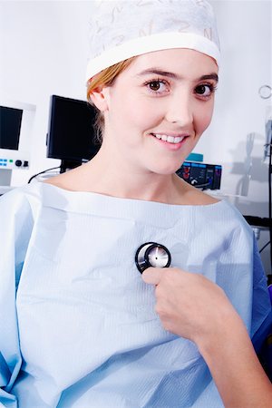 simsearch:625-01252179,k - Close-up of a doctor's hand holding a stethoscope and examining a female patient Stock Photo - Premium Royalty-Free, Code: 625-01250220