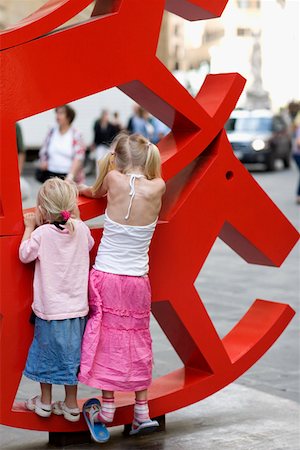 simsearch:625-01251739,k - Rear view of two girls climbing a rocking horse sculpture, Venice, Veneto, Italy Foto de stock - Sin royalties Premium, Código: 625-01250241