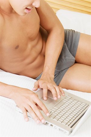 finger muscles - Mid section view of a man using a laptop Stock Photo - Premium Royalty-Free, Code: 625-01250275