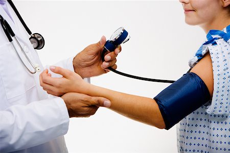 doctor checking pulse to patient - Mid section view of a male doctor measuring blood pressure of a female patient Stock Photo - Premium Royalty-Free, Code: 625-01250391