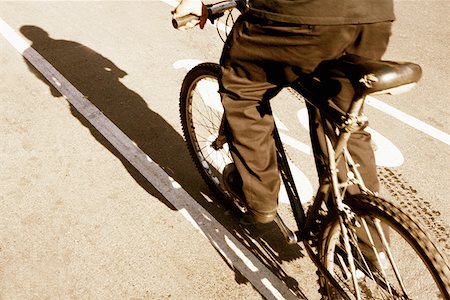 simsearch:625-01095436,k - Low section view of a man cycling Stock Photo - Premium Royalty-Free, Code: 625-01250448