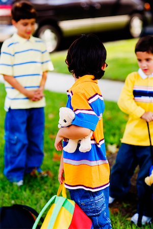 simsearch:625-01093217,k - Three schoolboys playing in a lawn Fotografie stock - Premium Royalty-Free, Codice: 625-01250631