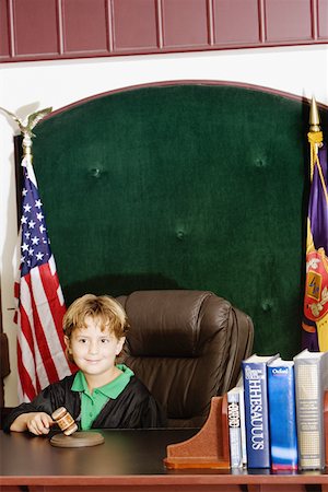 Boy imitating a judge in a courthouse Stock Photo - Premium Royalty-Free, Code: 625-01250790