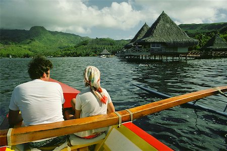 Rear view of a man and woman in a boat, Raiatea Island, Tahiti, Society Islands, French Polynesia Foto de stock - Sin royalties Premium, Código: 625-01250802