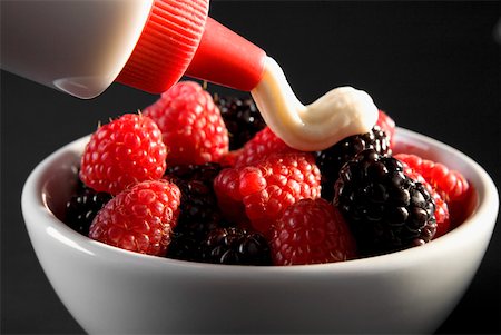 simsearch:625-01252133,k - Close-up of raspberries and blackberries in a bowl with cream poured on top Stock Photo - Premium Royalty-Free, Code: 625-01250838