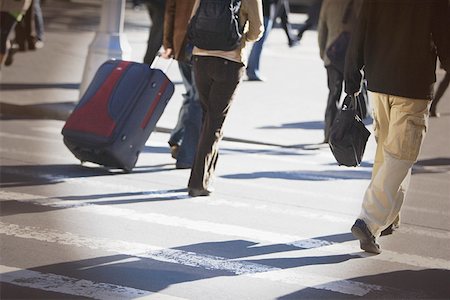 Low section view of men and women walking on the road Stock Photo - Premium Royalty-Free, Code: 625-01250996