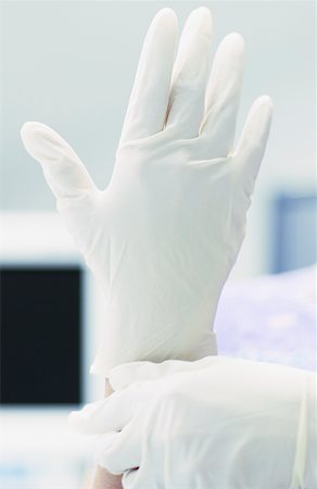 female doctor glove women only - Female doctor wearing surgical gloves Stock Photo - Premium Royalty-Free, Code: 625-01251037