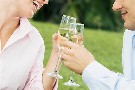 Close-up of a young couple toasting with champagne flutes Stock Photo - Premium Royalty-Free, Code: 625-01251164