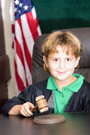 Boy imitating a judge in a courthouse Stock Photo - Premium Royalty-Free, Code: 625-01251187