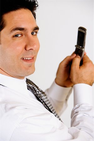 simsearch:625-01096675,k - Portrait of a businessman holding a mobile phone and smiling Stock Photo - Premium Royalty-Free, Code: 625-01251189