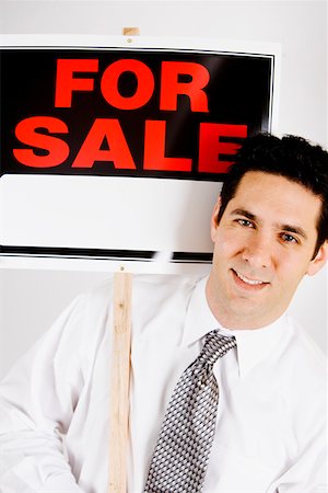 simsearch:625-01096675,k - Portrait of a businessman holding For Sale sign board Stock Photo - Premium Royalty-Free, Code: 625-01251379