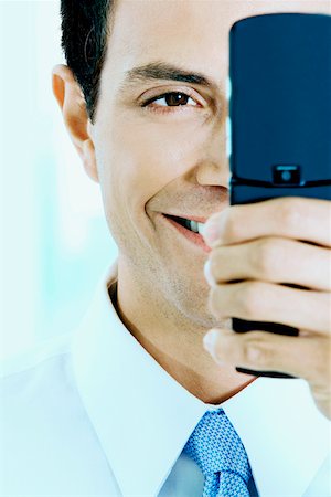 simsearch:625-01096675,k - Close-up of a businessman looking at a mobile phone Stock Photo - Premium Royalty-Free, Code: 625-01251780