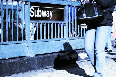 simbolo della metropolitana - Low section view of a man passing in front of a subway sign Fotografie stock - Premium Royalty-Free, Codice: 625-01251824