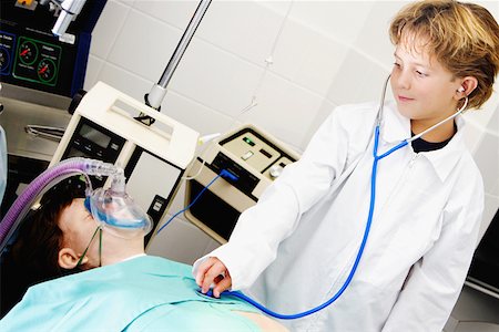 doctor listening boy - Boy imitating a doctor and examining a patient with a stethoscope Stock Photo - Premium Royalty-Free, Code: 625-01252269