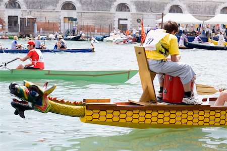 rowing a boat in venice - Rear view of a man sitting in a gondola, Venice, Veneto, Italy Stock Photo - Premium Royalty-Free, Code: 625-01252410