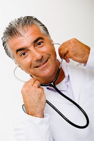 simsearch:625-02929220,k - Portrait of a male doctor holding a stethoscope and smiling Stock Photo - Premium Royalty-Free, Code: 625-01252448