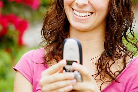 simsearch:625-01097695,k - Close-up of a young woman holding a mobile phone and smiling Foto de stock - Royalty Free Premium, Número: 625-01252474