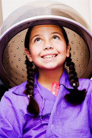 Close-up of a girl sitting under a hair dryer Stock Photo - Premium Royalty-Free, Code: 625-01252586