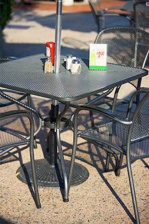 sidewalk cafe empty - Table and chairs at a sidewalk cafe Stock Photo - Premium Royalty-Free, Code: 625-01252594