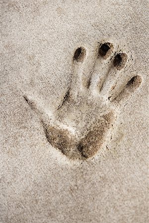Close-up of a handprint on a wall Stock Photo - Premium Royalty-Free, Code: 625-01264211