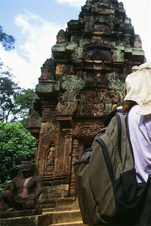 simsearch:625-01263765,k - Rear view of a person standing in front of a temple, Banteay Srei, Angkor, Siem Reap, Cambodia Stock Photo - Premium Royalty-Free, Code: 625-01264267