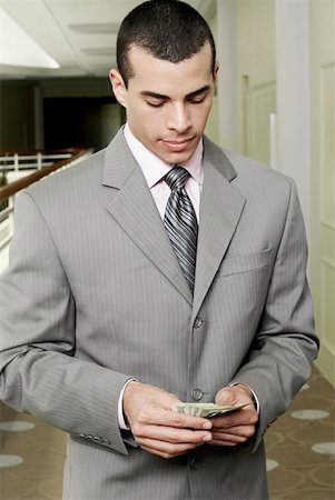 simsearch:625-00850993,k - Close-up of a businessman holding US paper currency Stock Photo - Premium Royalty-Free, Code: 625-01264286