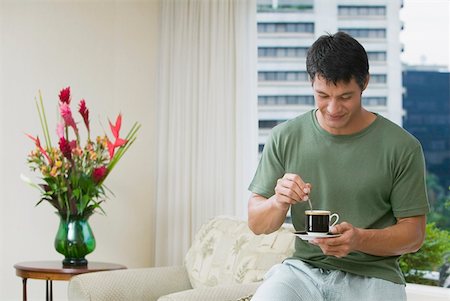 Mid adult man stirring tea with a teaspoon Stock Photo - Premium Royalty-Free, Code: 625-01264488