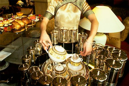 simsearch:640-02952966,k - Mid section view of a waitress pouring tea in tea cups, Pudong Shangri-La, Shanghai, China Stock Photo - Premium Royalty-Free, Code: 625-01264605