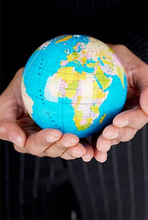 female hand globe - Mid section view of a businesswoman holding a globe Stock Photo - Premium Royalty-Free, Code: 625-01264909