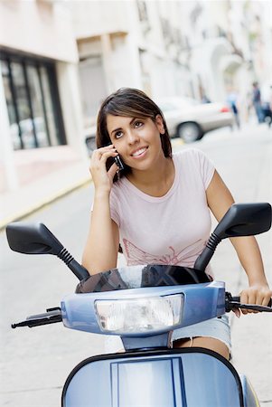 simsearch:625-01092988,k - Teenage girl riding on a motor scooter and talking on mobile phone Foto de stock - Royalty Free Premium, Número: 625-01265035