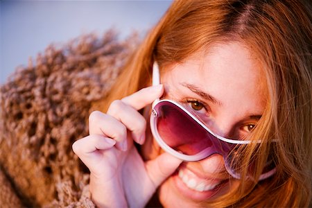 peeping fashion - Portrait of a mid adult woman peeking over her sunglasses Stock Photo - Premium Royalty-Free, Code: 625-01265049