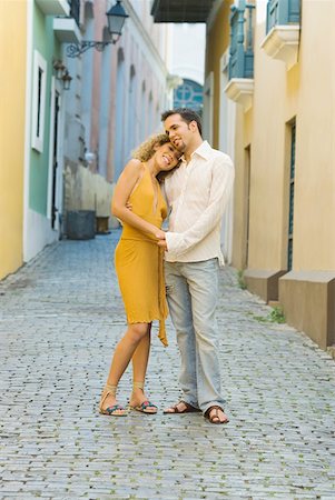 Side profile of a teenage girl and a mid adult man embracing each other on the street Stock Photo - Premium Royalty-Free, Code: 625-01265040