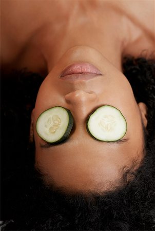 Close-up of a young woman with cucumber slices on her eyes Stock Photo - Premium Royalty-Free, Code: 625-01265146