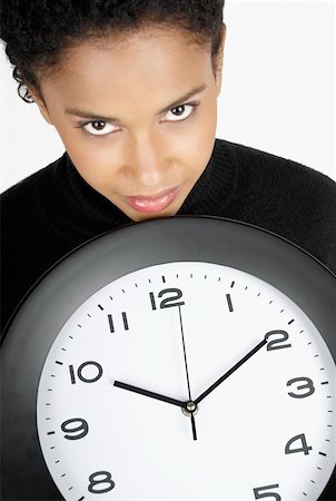 simsearch:625-01748576,k - Portrait of a businesswoman holding a clock Foto de stock - Royalty Free Premium, Número: 625-01260674