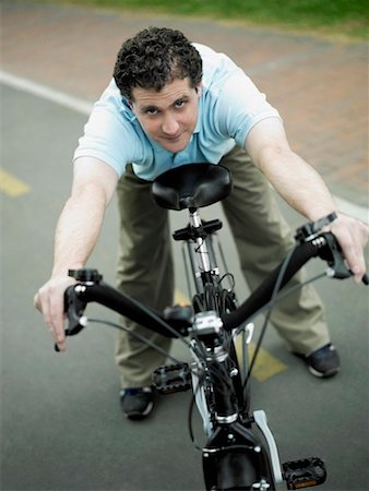 simsearch:625-01095436,k - High angle view of a mid adult man holding a bicycle Stock Photo - Premium Royalty-Free, Code: 625-01260794