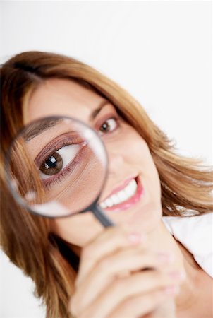 simsearch:625-01093712,k - Portrait of a businesswoman looking through a magnifying glass Stock Photo - Premium Royalty-Free, Code: 625-01260884