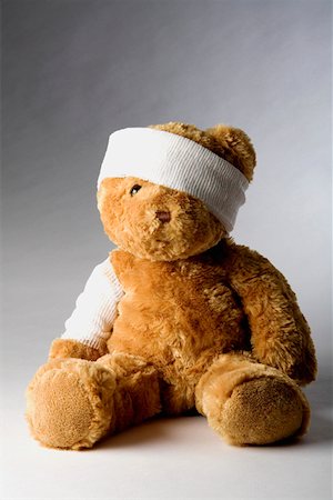 Close-up of a teddy bear with a bandage Stock Photo - Premium Royalty-Free, Code: 625-01260885