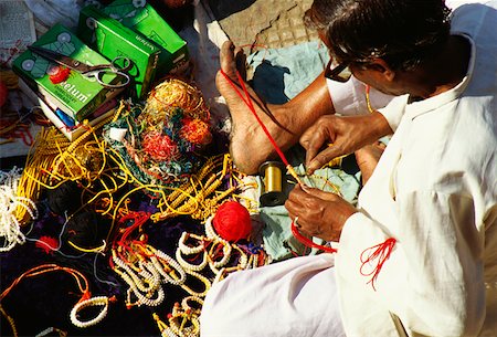 High angle view of a mature man making bracelets, Jaipur, Rajasthan, India Stock Photo - Premium Royalty-Free, Code: 625-01261040