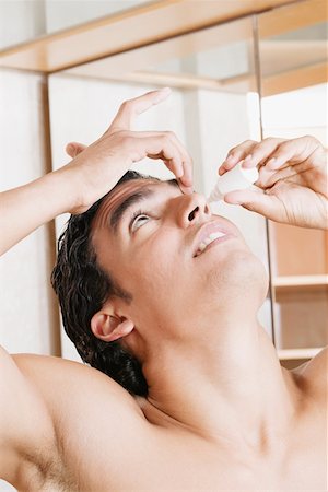 eye drops with eye dropper - Close-up of a young man pouring eyedrops into his eyes Stock Photo - Premium Royalty-Free, Code: 625-01261194