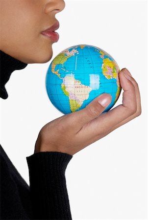 Side profile of a businesswoman holding a globe Stock Photo - Premium Royalty-Free, Code: 625-01261242