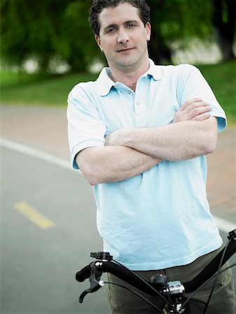 simsearch:625-01095436,k - Portrait of a mid adult man standing with a bicycle Stock Photo - Premium Royalty-Free, Code: 625-01261321