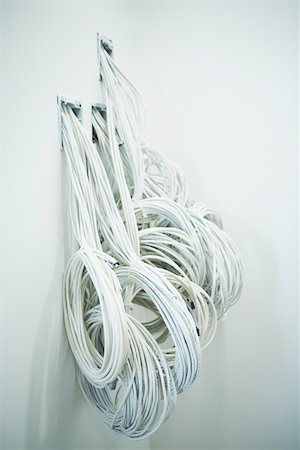 Close-up of a roll of cables coming out from a wall Stock Photo - Premium Royalty-Free, Code: 625-01261442